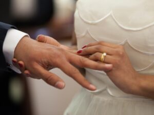 Photo of couple exchanging wedding rings