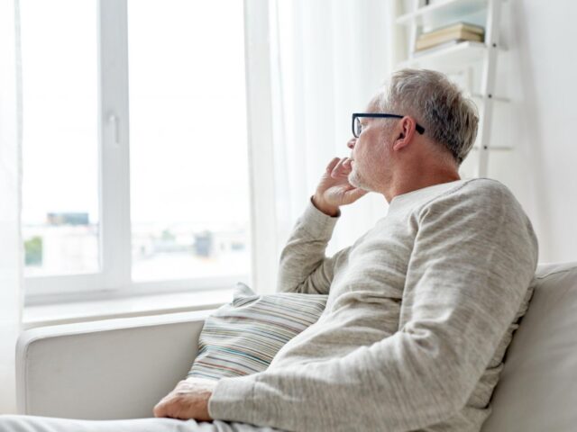 man looking out of window