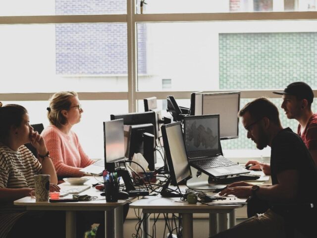 people at work on screens