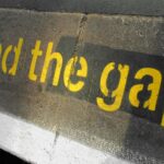 the words 'mind the gap' at a tube station