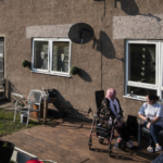 people sitting outside in a back yard