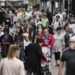 a crowd of people in a shopping area
