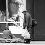 homeless people outside a Prada shop