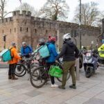 a group of delivery riders on bikes