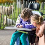 A carer with a child who uses a wheelchair