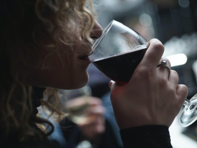 Photo of young woman drinking wine