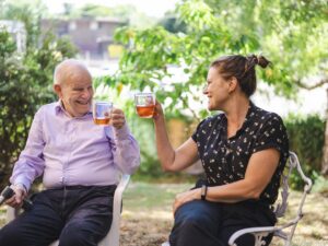 an older man with a walking stick and a woman