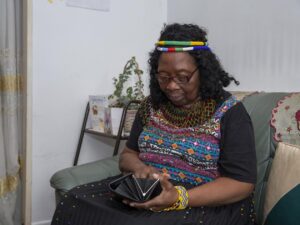 an older woman looks at the contents of her purse