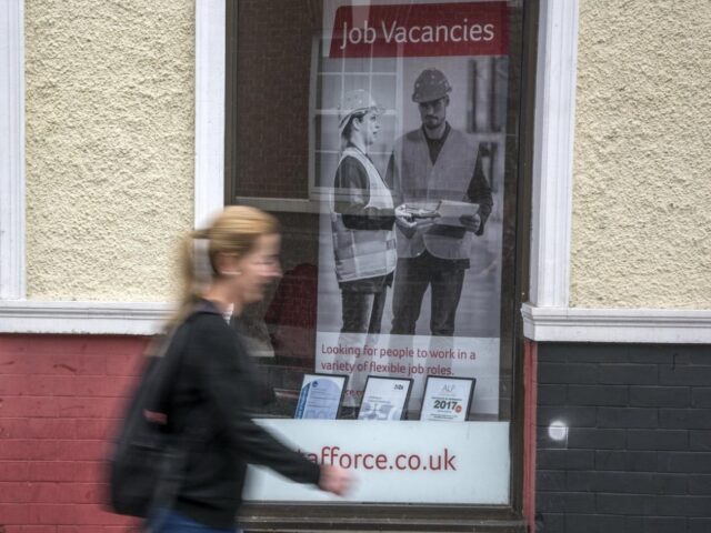 a woman walking past a job centre