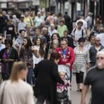 a crowd of people in a shopping area