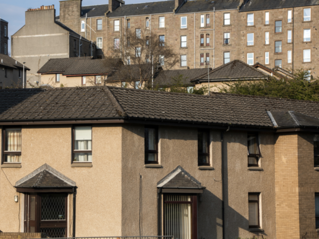 streets of houses of different kinds against a blue sky