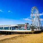 Clacton Pier, showing amusement arcade and big wheel against blue sky