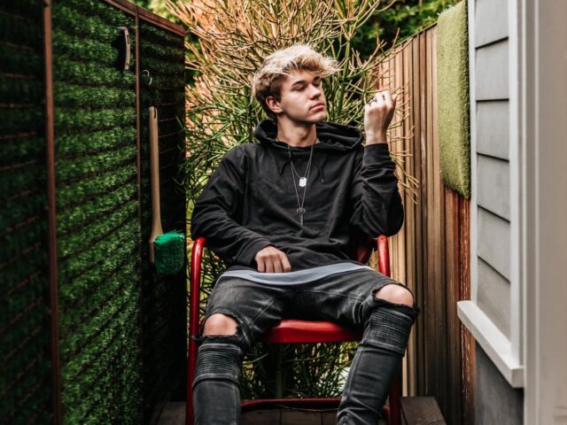 Young man in parents' back garden