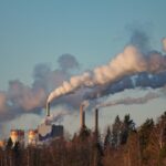 Photo of smoke emerging from a paper plant's chimneys by Daniel Moqvist on Unsplash