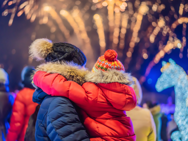 Mum and child looking at fireworks