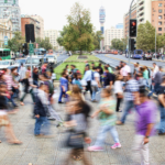 Photo of people crossing a busy city street