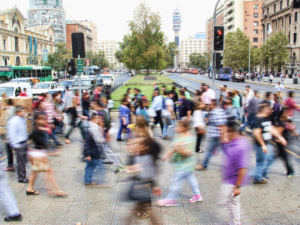 Photo of people crossing a busy city street