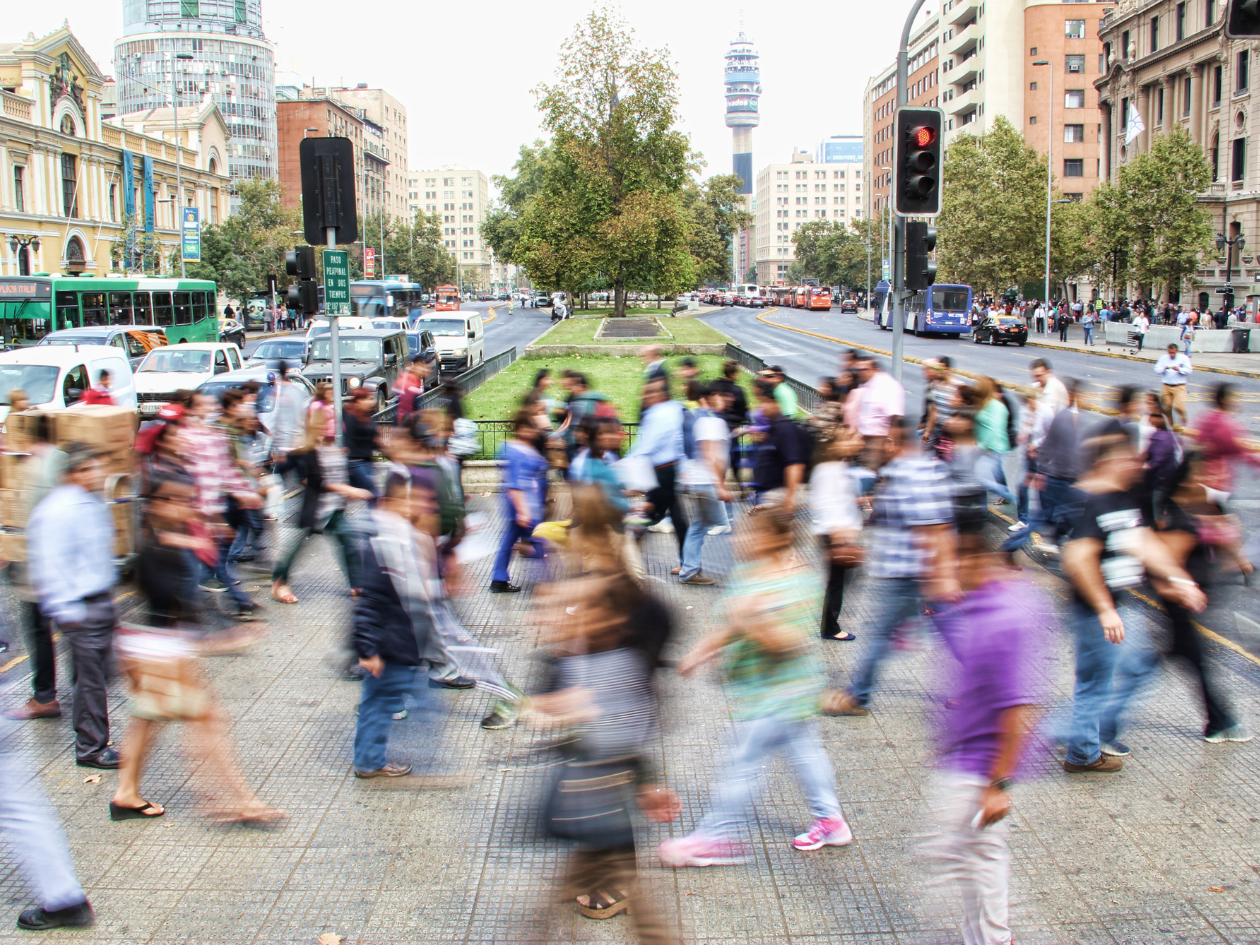 Photo of people crossing a busy city street