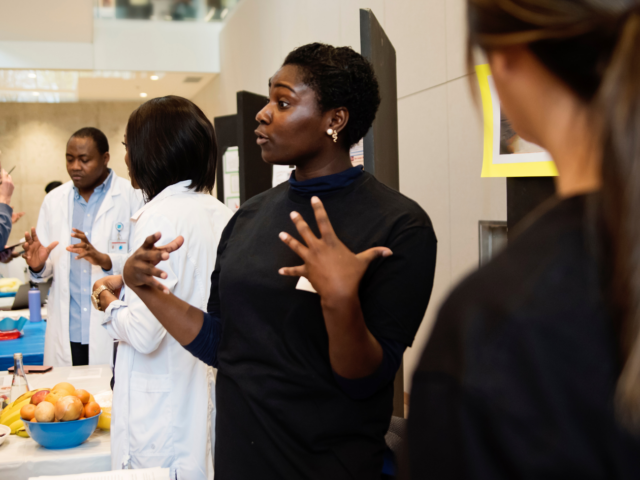 Researcher explaining work at a public engagement event.